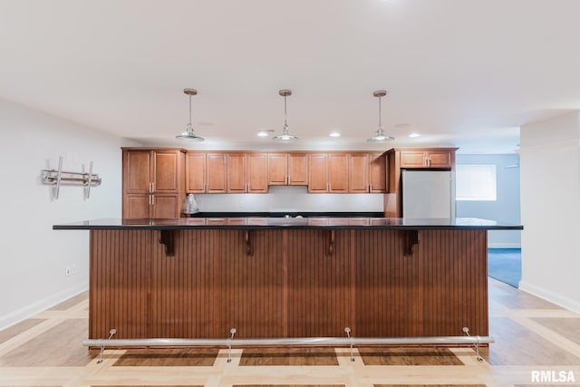 1506 Gleneagle Dr, Marion, IL 62959 - kitchen with dark countertops, freestanding refrigerator, a kitchen breakfast bar, pendant lighting, and recessed lighting