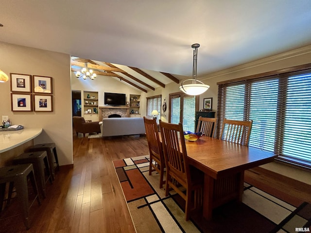 304 May Apple Ln, Carbondale, IL 62903 - dining area featuring wood-type flooring, a fireplace, and a chandelier