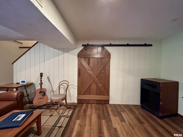 304 May Apple Ln, Carbondale, IL 62903 - living area with a barn door, wood finished floors, and wooden walls