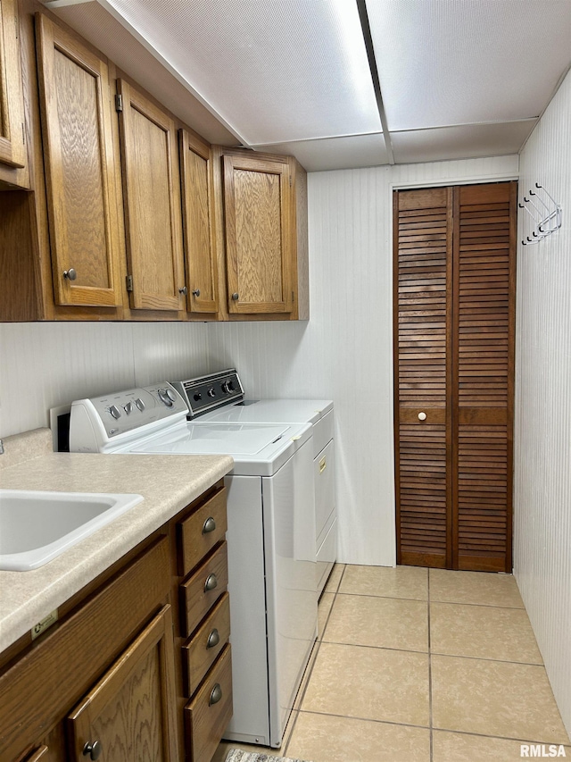 304 May Apple Ln, Carbondale, IL 62903 - laundry room with washing machine and clothes dryer, cabinet space, and light tile patterned floors