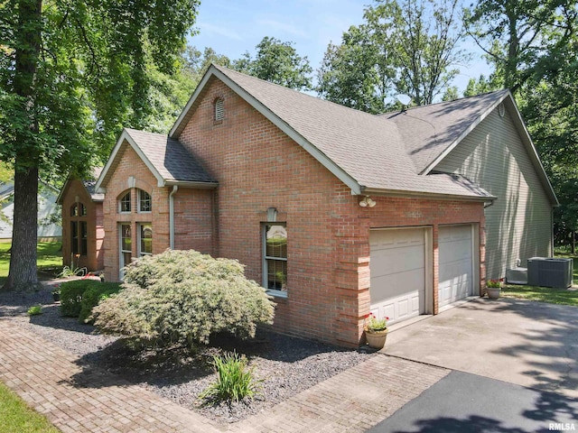 1818 Calico Rd, Marion, IL 62959 - view of front of home with brick siding, a garage, a shingled roof, and driveway