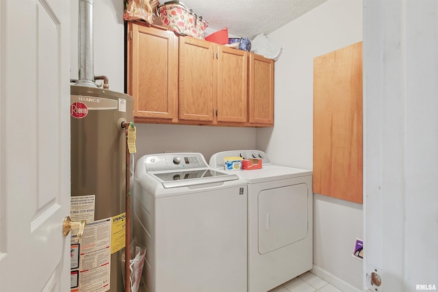 1818 Calico Rd, Marion, IL 62959 - laundry area featuring gas water heater, cabinet space, washer and clothes dryer, a textured ceiling, and light tile patterned floors