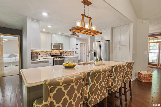 1818 Calico Rd, Marion, IL 62959 - kitchen featuring stainless steel appliances, dark wood finished floors, tasteful backsplash, white cabinets, and recessed lighting