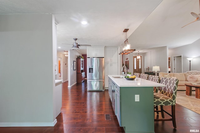 1818 Calico Rd, Marion, IL 62959 - kitchen featuring stainless steel fridge, a breakfast bar area, dark wood-style floors, white cabinets, and light countertops