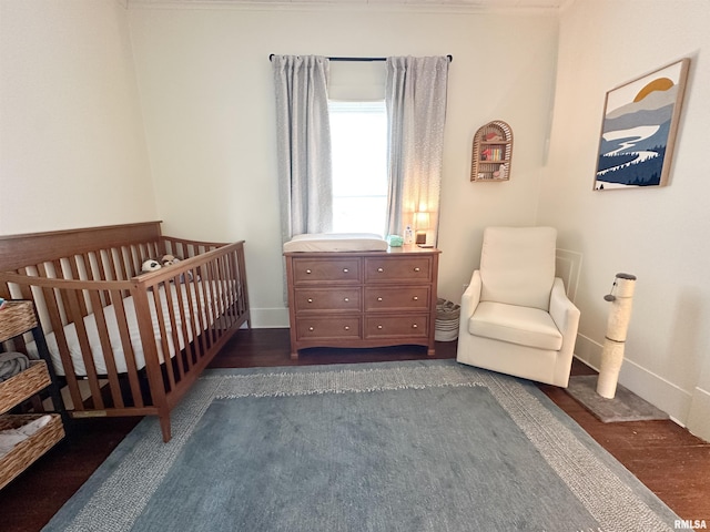 817 W Hendrickson St, Marion, IL 62959 - bedroom featuring a crib and dark wood-style flooring