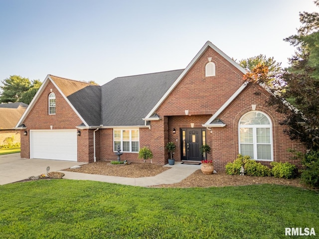 1600 S Eugene Ln, Marion, IL 62959 - view of front of house with brick siding, driveway, a front yard, and a shingled roof