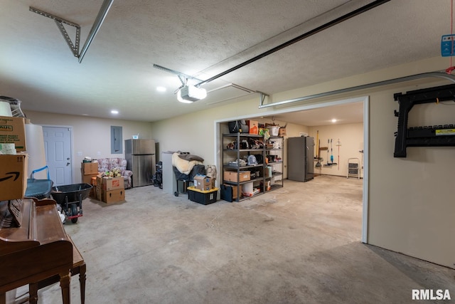 1600 S Eugene Ln, Marion, IL 62959 - garage featuring electric panel, refrigerator, freestanding refrigerator, and a garage door opener