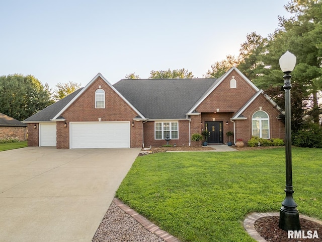 1600 S Eugene Ln, Marion, IL 62959 - traditional home with a front lawn, concrete driveway, brick siding, and an attached garage