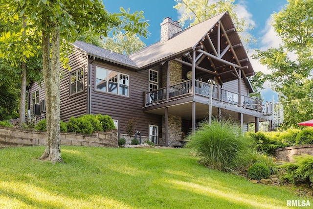 3525 Parrish Ridge Ln, Goreville, IL 62939 - back of property with stone siding, a chimney, a yard, and faux log siding