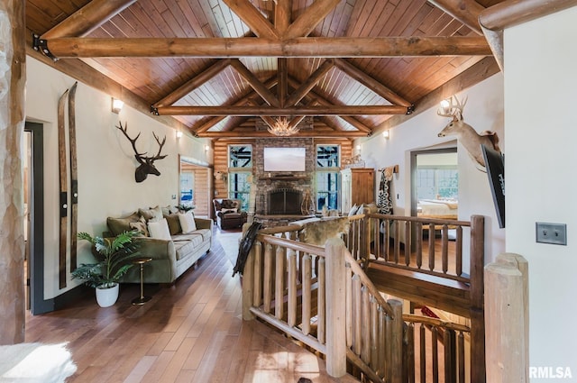 3525 Parrish Ridge Ln, Goreville, IL 62939 - living room featuring a wood ceiling with exposed beams, hardwood / wood-style floors, high vaulted ceiling, and a fireplace