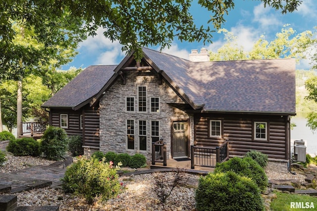 3525 Parrish Ridge Ln, Goreville, IL 62939 - log home featuring a chimney, stone siding, a wooden deck, faux log siding, and roof with shingles