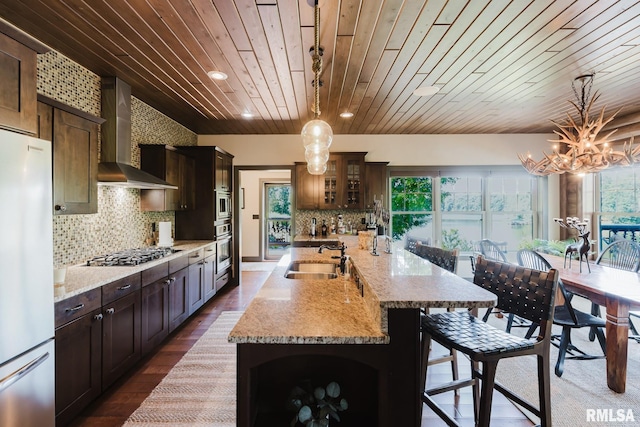 3525 Parrish Ridge Ln, Goreville, IL 62939 - kitchen with stainless steel appliances, wooden ceiling, wall chimney exhaust hood, dark wood-style floors, and backsplash