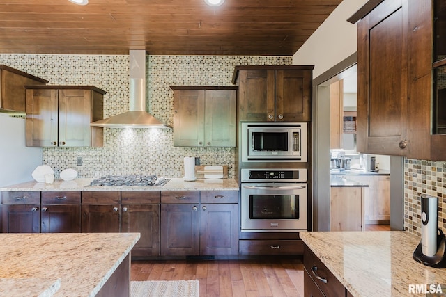 3525 Parrish Ridge Ln, Goreville, IL 62939 - kitchen featuring stainless steel appliances, wall chimney exhaust hood, wooden ceiling, light stone counters, and hardwood / wood-style floors