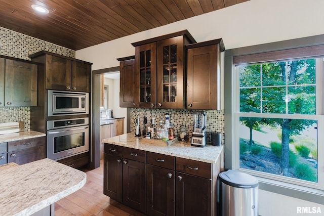 3525 Parrish Ridge Ln, Goreville, IL 62939 - kitchen with appliances with stainless steel finishes, tasteful backsplash, dark brown cabinetry, glass insert cabinets, and wood ceiling