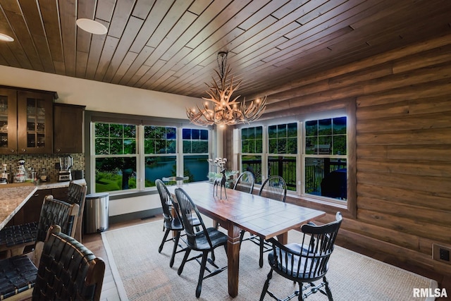3525 Parrish Ridge Ln, Goreville, IL 62939 - dining area featuring a chandelier, rustic walls, wood ceiling, and wood finished floors
