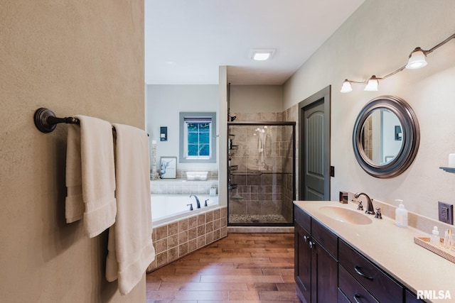 3525 Parrish Ridge Ln, Goreville, IL 62939 - bathroom featuring hardwood / wood-style floors, a stall shower, a garden tub, and vanity