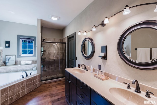3525 Parrish Ridge Ln, Goreville, IL 62939 - bathroom with wood finished floors, a shower stall, a garden tub, and double vanity