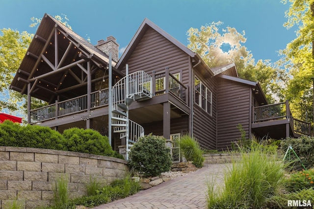 3525 Parrish Ridge Ln, Goreville, IL 62939 - back of house with log veneer siding, stairs, a deck, and a chimney