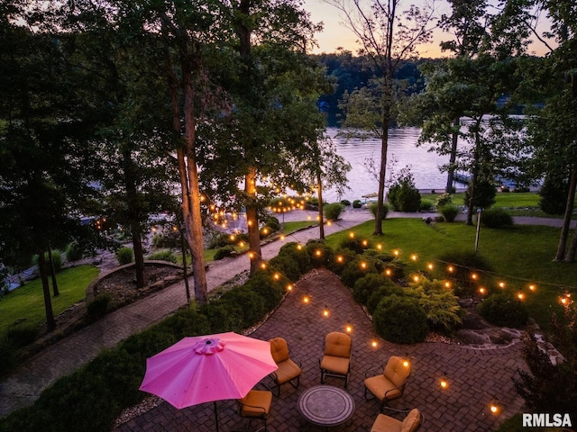3525 Parrish Ridge Ln, Goreville, IL 62939 - yard at dusk with a patio, a lawn, and a water view