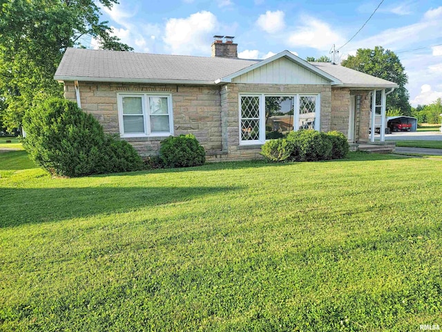 119 S 6th St SE, Clay City, IL 62824 - ranch-style home with stone siding, a front lawn, and a chimney