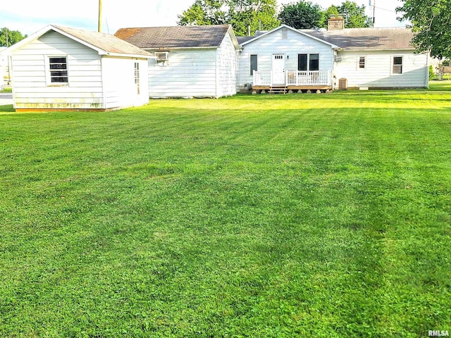 119 S 6th St SE, Clay City, IL 62824 - view of green lawn featuring a deck and a storage shed