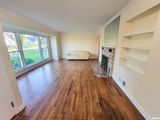 119 S 6th St SE, Clay City, IL 62824 - living room with dark wood-style flooring, built in shelves, crown molding, and a fireplace