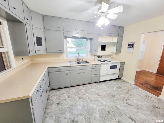 119 S 6th St SE, Clay City, IL 62824 - kitchen featuring white range with electric stovetop, gray cabinets, ceiling fan, and light countertops