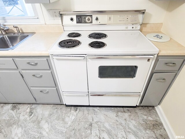 119 S 6th St SE, Clay City, IL 62824 - kitchen with range with two ovens, light countertops, and gray cabinetry