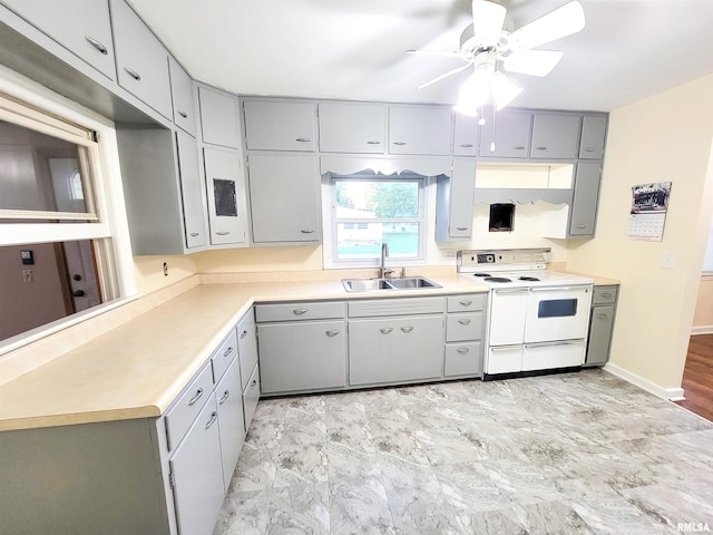 119 S 6th St SE, Clay City, IL 62824 - kitchen featuring white electric range oven, gray cabinets, a ceiling fan, and light countertops