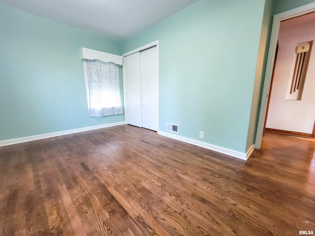 119 S 6th St SE, Clay City, IL 62824 - unfurnished bedroom with dark wood-style floors and a closet