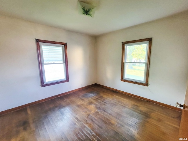 119 S 6th St SE, Clay City, IL 62824 - spare room with plenty of natural light and dark wood finished floors