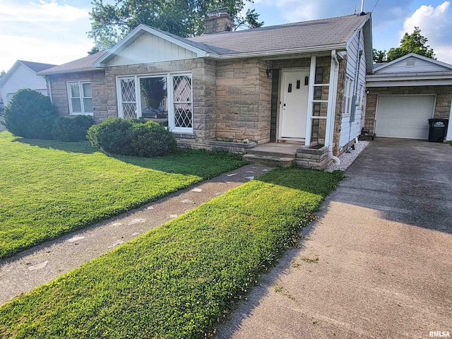 119 S 6th St SE, Clay City, IL 62824 - ranch-style home featuring stone siding, a chimney, driveway, a front lawn, and an attached garage