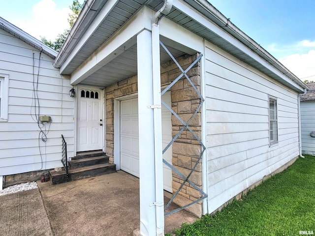 119 S 6th St SE, Clay City, IL 62824 - view of exterior entry with a garage