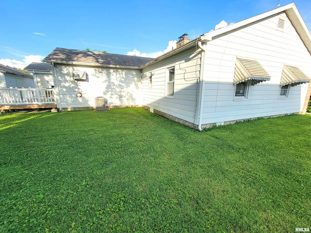 119 S 6th St SE, Clay City, IL 62824 - back of property with a chimney, a lawn, and a deck