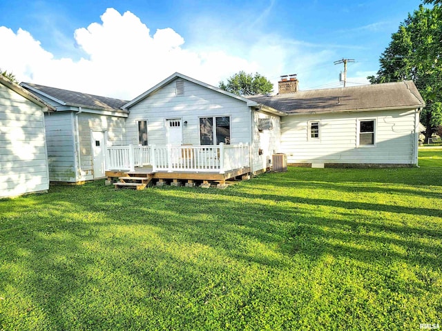 119 S 6th St SE, Clay City, IL 62824 - back of house with a chimney, a yard, a wooden deck, and a shingled roof