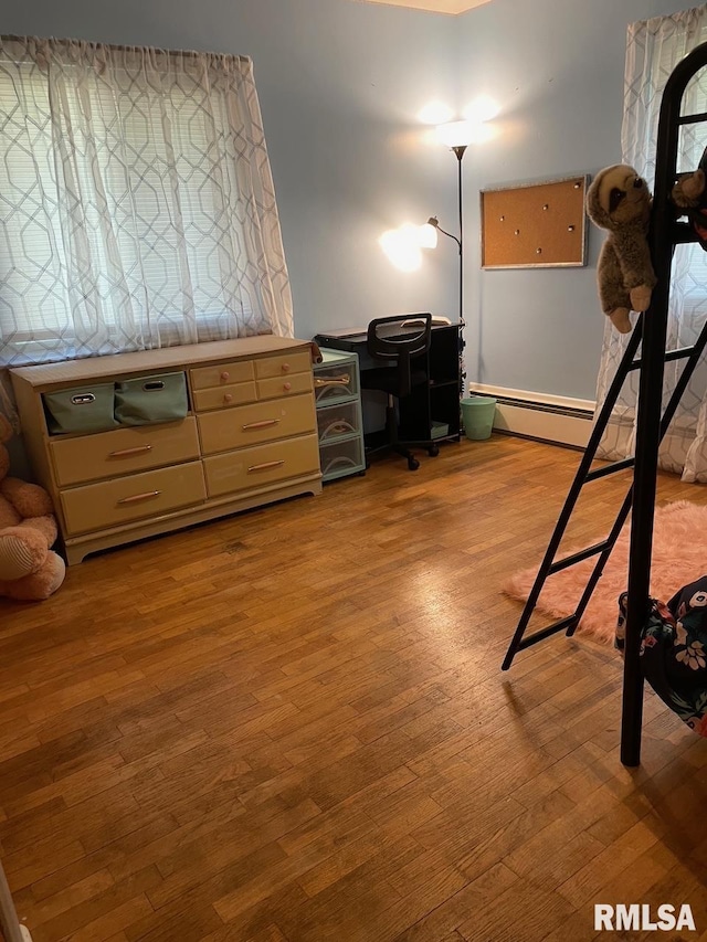 303 S College Blvd, Carmi, IL 62821 - bedroom with wood finished floors and baseboard heating
