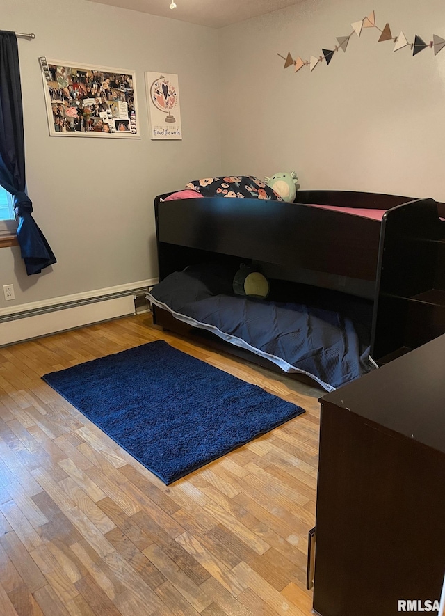 303 S College Blvd, Carmi, IL 62821 - bedroom with wood finished floors and baseboard heating
