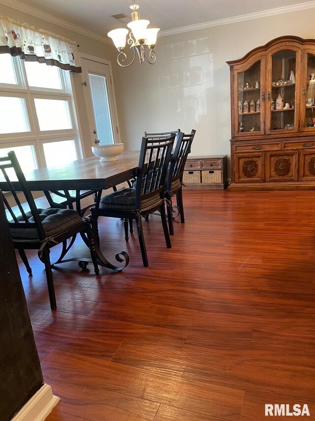 303 S College Blvd, Carmi, IL 62821 - dining space with a chandelier, ornamental molding, and wood finished floors