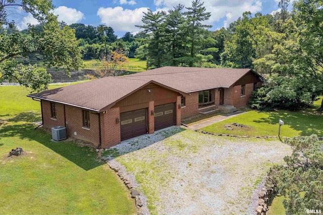 2723 Country Club Rd, Carbondale, IL 62901 - view of front facade with dirt driveway, brick siding, a front lawn, and a garage