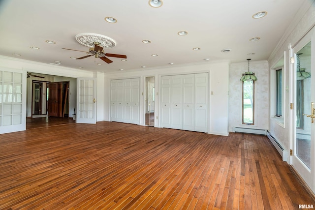 2723 Country Club Rd, Carbondale, IL 62901 - unfurnished bedroom featuring hardwood / wood-style flooring, two closets, ornamental molding, recessed lighting, and a baseboard radiator