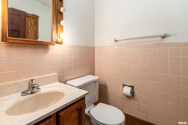 2723 Country Club Rd, Carbondale, IL 62901 - bathroom featuring wallpapered walls, tile walls, vanity, and wainscoting