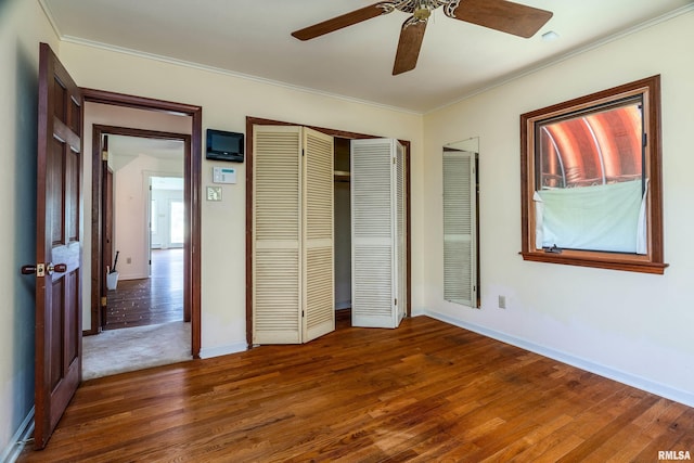 2723 Country Club Rd, Carbondale, IL 62901 - unfurnished bedroom featuring wood finished floors, ornamental molding, a closet, and a ceiling fan