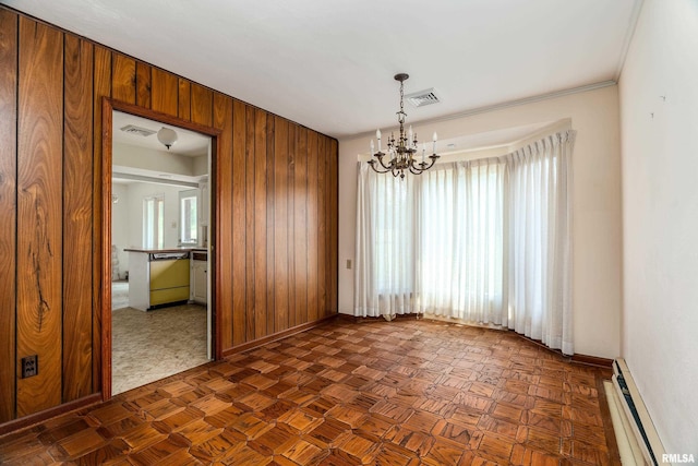 2723 Country Club Rd, Carbondale, IL 62901 - spare room with a baseboard radiator, wood walls, and a chandelier