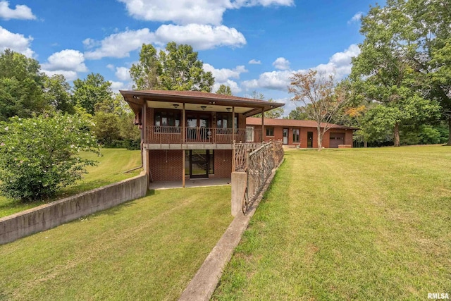 2723 Country Club Rd, Carbondale, IL 62901 - rear view of property featuring a lawn, a deck, ceiling fan, brick siding, and a garage