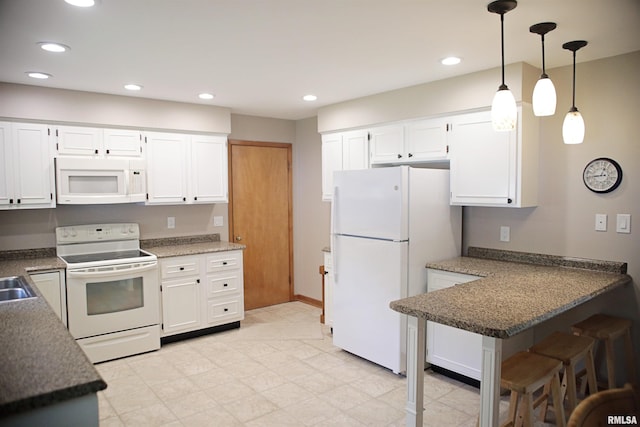 203 Skyline Dr, Marion, IL 62959 - kitchen featuring white appliances, a peninsula, white cabinetry, hanging light fixtures, and recessed lighting