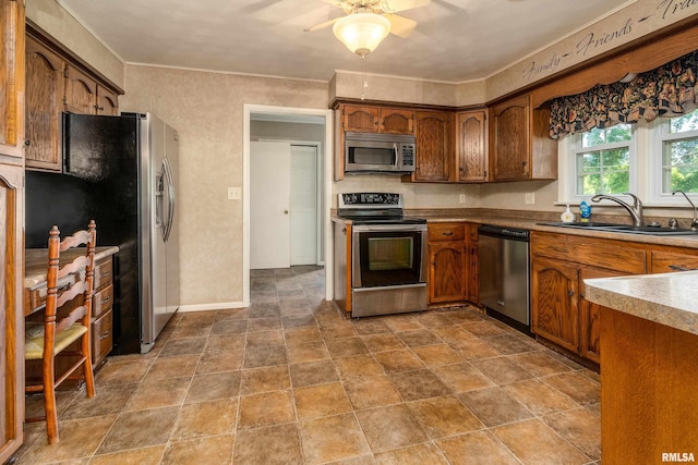 4341 Market Rd, Marion, IL 62959 - kitchen with appliances with stainless steel finishes, a ceiling fan, stone finish flooring, brown cabinetry, and ornamental molding