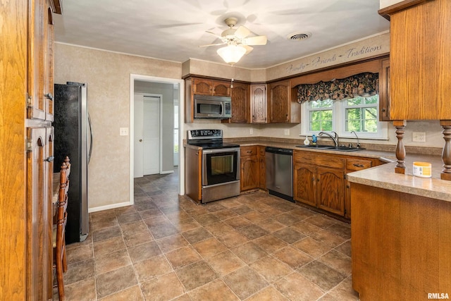 4341 Market Rd, Marion, IL 62959 - kitchen with stainless steel appliances, ceiling fan, stone finish floors, light countertops, and brown cabinets