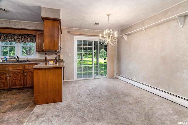 4341 Market Rd, Marion, IL 62959 - kitchen with a baseboard heating unit, brown cabinets, a chandelier, hanging light fixtures, and dark carpet