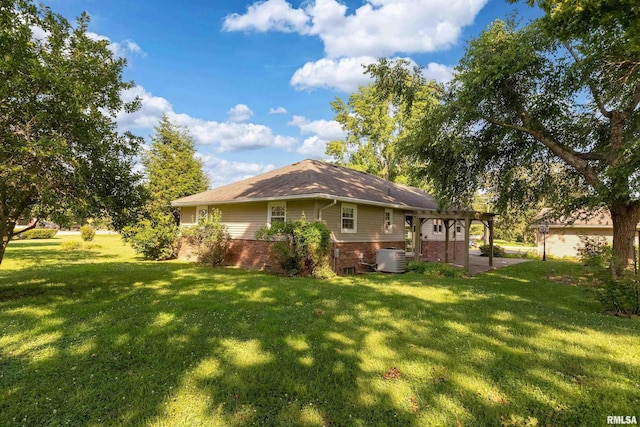 4341 Market Rd, Marion, IL 62959 - rear view of house with a pergola, brick siding, a lawn, and a patio area