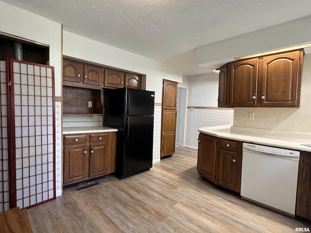 1409 N Van Buren, Marion, IL 62959 - kitchen featuring dishwasher, freestanding refrigerator, light wood-style floors, light countertops, and a textured ceiling
